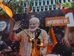 An Indian supporter of Indian Prime Minister Narendra Modi's Bharatiya Janata Party (BJP) celebrates the election results outside the BJP headquarters in Mumbai on May 23, 2019. (AFP/ File Photo)