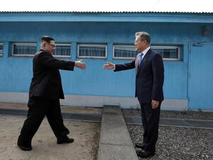 North Korea's leader Kim Jong Un (L) shakes hands with South Korea's President Moon Jae-in (R) at the Military Demarcation Line that divides their countries ahead of their summit at the truce village of Panmunjom on April 27, 2018. (AFP PHOTO)