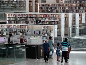 People visit the interior of the Qatar National Library in the capital Doha on May 19, 2019. The Gulf's largest book collection, Qatar's National Library is one-year-old and has enhanced ties with libraries outside the region as the anti-Doha boycott drags on while also wooing younger readers. (AFP/ File Photo)