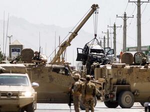 International forces belonging to NATO's Resolute Support mission remove a damage vehicle with a crane at the site of a car bomb attack in Kabul on May 31, 2019. (AFP/File Photo)