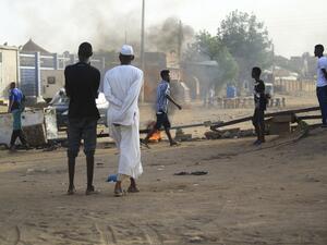 Locals set tyres on fire and block a sidestreet leading to their neighbourhood in the Sudanese capital Khartoum to stop military vehicles from driving through the area on June 4, 2019.. (AFP)