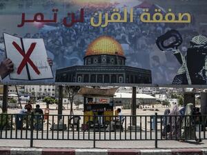 A picture taken on June 16, 2019, shows a poster in Gaza City denouncing the US Middle East peace plan dubbed the "deal of the century". Arabic writing on poster reads "The deal of the century will not pass".  (MAHMUD HAMS / AFP) A picture taken on June 16, 2019, shows a poster in Gaza City denouncing the US Middle East peace plan dubbed the "deal of the century". Arabic writing on poster reads "The deal of the century will not pass".  (MAHMUD HAMS / AFP)