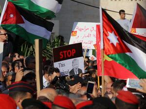 Protesters hold an anti-Donald Trump signs and Jordanian flags during the "March of Anger" demonstration leading to the US embassy headquarters in the Jordanian capital Amman on June 21, 2019, against the US President's "Deal of the Century" and the US-led Middle East economic conference in Bahrain. (Khalil MAZRAAWI / AFP) Protesters hold an anti-Donald Trump signs and Jordanian flags during the "March of Anger" demonstration leading to the US embassy headquarters in the Jordanian capital Amman on June 21, 2019, against the US President's "Deal of the Century" and the US-led Middle East economic conference in Bahrain. (Khalil MAZRAAWI / AFP)