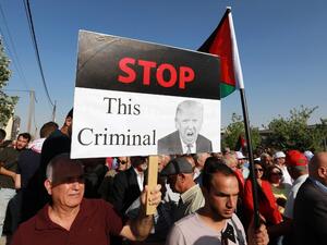 A protester holds an anti-Donald Trump sign as he marches with others during the "March of Anger" demonstration leading to the US embassy headquarters in the Jordanian capital Amman on June 21, 2019, against US President Donald Trump's "Deal of the Century" and the US-led Middle East economic conference in Bahrain.  (Khalil MAZRAAWI / AFP) A protester holds an anti-Donald Trump sign as he marches with others during the "March of Anger" demonstration leading to the US embassy headquarters in the Jordanian capital Amman on June 21, 2019, against US President Donald Trump's "Deal of the Century" and the US-led Middle East economic conference in Bahrain.  (Khalil MAZRAAWI / AFP)