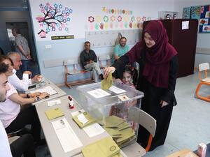 A woman, flanked by a girl, casts her vote at a polling station during Istanbul mayoral elections re-run, in Istanbul. Istanbul went back to the polls on June 23, 2019 in a re-run of the mayoral election. (AFP/ File Photo)