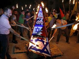 Palestinians burn a structure displaying the Israeli flag and a portrait of King Hamad al-Khalifa of Bahrain during protests against a US-led meeting this week in the Gulf kingdom on the Palestinian-Israeli conflict, in the West Bank city of Hebron on June 24, 2019. Palestinians burn a structure displaying the Israeli flag and a portrait of King Hamad al-Khalifa of Bahrain during protests against a US-led meeting this week in the Gulf kingdom on the Palestinian-Israeli conflict, in the West Bank city of Hebron on June 24, 2019. (AFP/ File Photo)