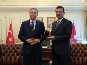 Istanbul's new mayor Ekrem Imamoglu (R) poses with Istanbul's Governor and acting Mayor Ali Yerlikaya during a handover ceremony at the Town Hall in Istanbul, on June 27, 2019.  CAN EROK / POOL / AFP
