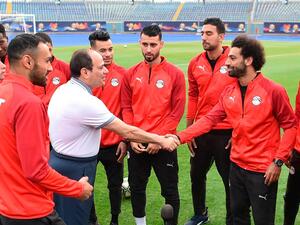 Egyptian President Abdel Fattah El Sisi greets Egypt's UEFA Champions League winning Liverpool forward Mohamed Salah during the national team's training camp at the 30 June Stadium in Cairo on June 15, 2019. (AFP)