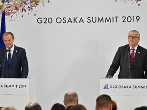 Tusk and European Commission President Jean-Claude Juncker attend a press conference at the G20 Osaka Summit  (AFP)