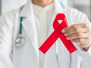 Aids red ribbon in doctor's hand for World aids day and national HIV/AIDS and aging awareness month concept. (Shutterstock/ File Photo)
