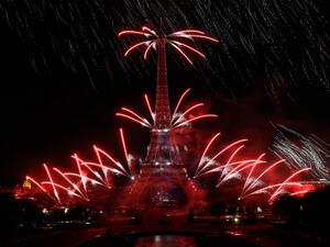 Fireworks explode from the Eiffel Tower and above the Trocadero Gardens as part of the annual Bastille Day celebrations in Paris on July 14, 2019. (GEOFFROY VAN DER HASSELT / AFP)