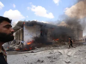 Syrian civilians react following an airstrike by Syrian regime forces in Maar Shurin on the outskirts of Maaret al-Numan in northwest Syria  (AFP)