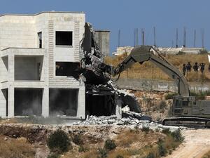 Israeli security forces tearing down one of the Palestinian buildings still under construction which have been issued notices to be demolished in the West Bank village of Dar Salah. (AFP/ File Photo)