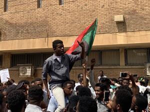 A Sudanese protester is lifted on the shoulders of another while chanting slogans during a demonstration commemorating protesters killed during past clashes, in the centre of the capital Khartoum on July 23, 2019.  Haitham EL-TABEI / AFP