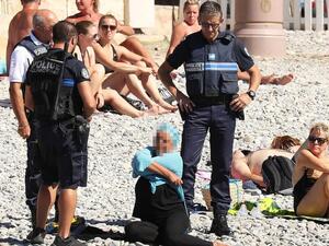 Police in France in 2016 policing what Muslim women wear at a beach. (AFP)