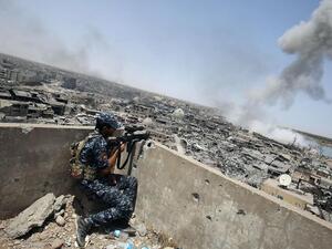 An Iraqi forces sniper looks on as smoke billows, following an airstrike by US-led international coalition forces targeting ISIS in the Old City of Mosul on July 9, 2017. (AFP/ File Photo)