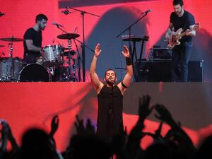 Hamed Sinno, the lead singer of Lebanese band Mashrou Leila, performs on stage at the Dubai International Marine Club. (Courtesy AFP / KARIM SAHIB)