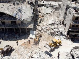In this aerial picture, members of the Syrian civil defence, known as the White Helmets use an excavator to search for victims under the rubble following a reported Russian air strike on Maaret al-Numan in Syria's northwestern Idlib province on July 22, 2019 .(AFP/ File Photo)
