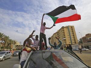 Sudanese protesters wave their national flag during a demonstration called for by the Sudanese Professionals Association (SPA) to denounce the July 29 Al-Obeid killings, in the capital Khartoum on August 1, 2019. (AFP/ File Photo)