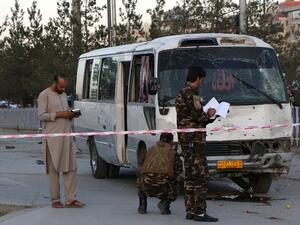 Afghan security personnel investigate a damage bus  (AFP)
