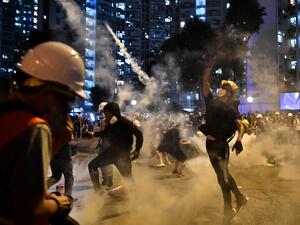Protesters throw back tear gas fired by the police in Wong Tai Sin during a general strike in Hong Kong on August 5, 2019, as simultaneous rallies were held across seven districts. (AFP/ File Photo)