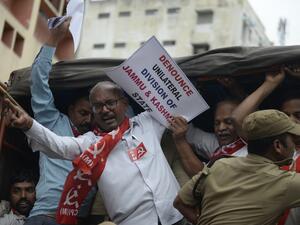Members of the Communist Party of India are detained by police at a protest in Hyderabad  (AFP)