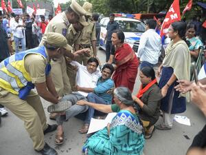 Members of the Communist Party of India are detained by police at a protest in Hyderabad (AFP)