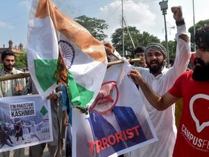 Students of Islami Jamiat-e-Talaba (IJT), a wing of religious political party Pakistan Jamaat-e-Islami (JI), burn a photograph of Indian Prime Minister Narendra Modi and an Indian flag during a protest in Lahore on August 7, 2019. (AFP)