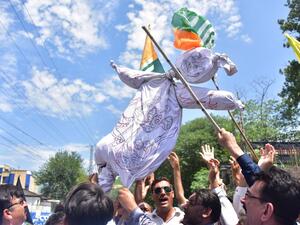 Pakistani Kashmiri hold an effigy of Indian Prime Minister Narendra Modi during a protest in Muzaffarabad, the capital of Pakistan-controlled Kashmir, on August 8, 2019. 
