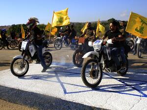 Hezbollah members ride their motorcycles in the Lebanese village of Aitaroun (AFP)