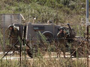 Lebanese village of Kfar Kila shows Israeli soldiers behind the border fence in the Israeli village of Mutella. (Mahmoud ZAYYAT / AFP)