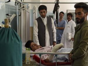 A wounded man receives treatment as people gather around him at the Wazir Akbar Khan hospital after a deadly bomb blast in a wedding hall in Kabul on August 18, 2019. (AFP/ File Photo)