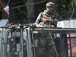 Indian army soldier stands alert in a truck while travelling in a convoy in Srinagar (AFP)