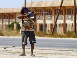 A fighter loyal to the internationally-recognised Government of National Accord (GNA) points his gun toward enemy lines during clashes with forces loyal to strongman Khalifa Haftar, in Espiaa. (AFP/ File Photo)