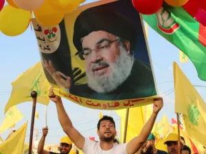 Supporters of the Lebanese Shiite Hezbollah movement carry ballons, party flags and a photograph of the movement's leader Hasan Nasrallah, in the town of Al-Ain in Lebanon's Bekaa valley on August 25, 2019. (AFP/ File Photo)