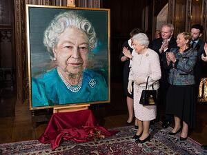 The Queen and the then deputy first minister of Northern Ireland Martin McGuinness, a former IRA commander, admire a portrait of the monarch in London in 2016. (Daily Mail)