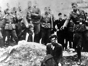 Amazon has removed an assortment of clothes sold on its UK site emblazoned with a notorious Holocaust photo in which a Jew in Ukraine is kneeling in front of a mass grave as a Nazi officer points a gun to his head, moments before shooting him (Twitter)