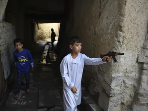 Afghan children play with plastic toy guns (AFP)