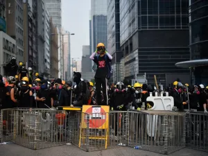 Protesters face off with riot police at Kowloon Bay in Hong Kong on August 24, 2019, in the latest opposition to a planned extradition law that has since morphed into a wider call for democratic rights in the semi-autonomous city. (AFP)