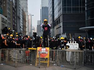 Protesters face off with riot police at Kowloon Bay in Hong Kong on August 24, 2019, in the latest opposition to a planned extradition law that has since morphed into a wider call for democratic rights in the semi-autonomous city. (AFP)