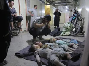 A man mourns over the bodies of his three children and their cousin at a morgue in the basement of a makeshift hospital following a reported airstrike by Syrian regime forces in Maaret al-Numan in Syria's northwestern Idlib province on August 28, 2019. (Zein Al RIFAI / AFP)