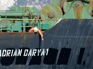 A crew member checks the new name of Iranian oil tanker Adrian Darya, formerly known as Grace 1, off the coast of Gibraltar. The United States on August 30, 2019. (AFP/ File Photo)