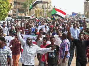 People wave the old and current flags of Sudan as they chant slogans during a mass demonstration near the presidential palace in Sudan's capital Khartoum on September 12, 2019, calling for the appointment of a new permanent chief of judiciary and prosecutor general. (AFP/ File Photo)