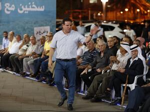 The head of the mainly Arab Joint List alliance Ayman Odeh gestures to supporters during an electoral campaign rally in the northern Arab-Israeli town of Sakhnin on September 15, 2019. (AFP/ File Photo)