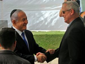 Israeli Prime Minister Benjamin Netanyahu (L) greets Benny Gantz, leader of Blue and White party, at a memorial ceremony for late Israeli president Shimon Peres, at Mount Herzl in Jerusalem on September 19, 2019. GIL COHEN-MAGEN / AFP