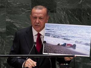Turkey's President Recep Tayyip Erdogan holds up a photo as he speaks during the 74th Session of the United Nations General Assembly at UN Headquarters in New York, September 24, 2019. (Johannes EISELE / AFP)
