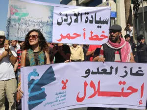 Jordanian protesters hold slogans reading, "no to normalisation with the Zionist enemy", "gas, enemy, occupation" during a protest in Amman in 2016 (AFP)