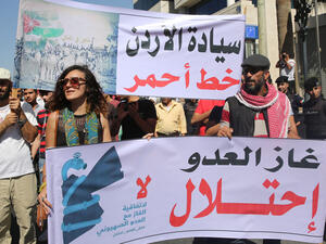 Jordanian protesters hold slogans reading, "no to normalisation with the Zionist enemy", "gas, enemy, occupation" during a protest in Amman in 2016 (AFP)
