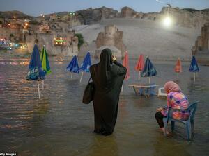 A woman takes a picture of the 12,000 year old ancient city of Hasankeyf, on the banks of the Tigris, in southeastern Turkey on August 17, 2019. (AFP)