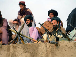 Afghan Taliban fighters listen to Mullah Mohammad Rasool Akhund (unseen), the newly appointed leader of a breakaway faction of the Taliban, at Bakwah in the western province of Farah. (AFP/ File Photo)